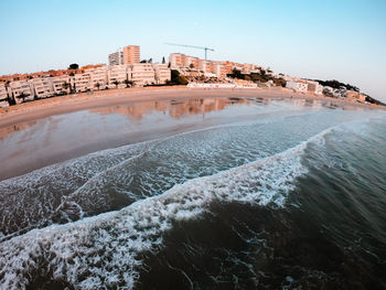 View of building by sea against clear sky