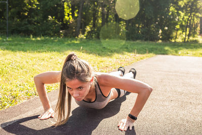 Side view of woman exercising in park