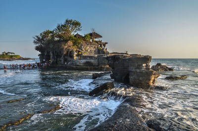 Tanah lot by sea against sky