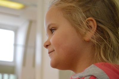 Close-up of girl looking away at home