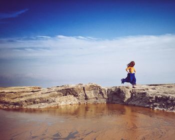 Full length of woman standing in water