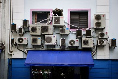 Low angle view of air conditioners against building