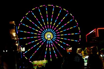 Low angle view of ferris wheel at night