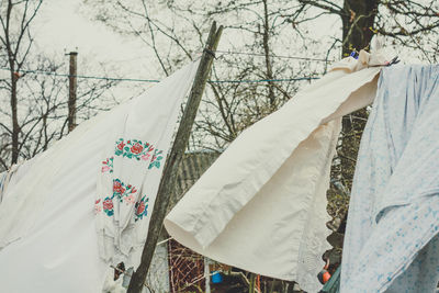 Close up fresh washed clothes on clothesline waving in wind concept photo