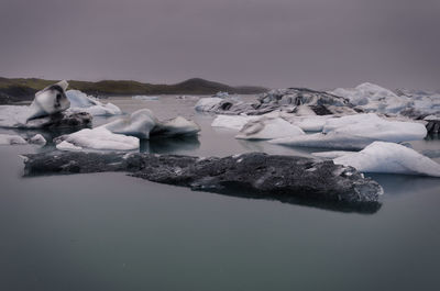 Frozen lake against sky during winter