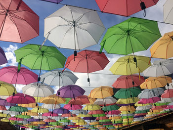 Low angle view of multi colored umbrellas hanging at market stall