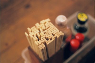 High angle view of chopsticks in container on table