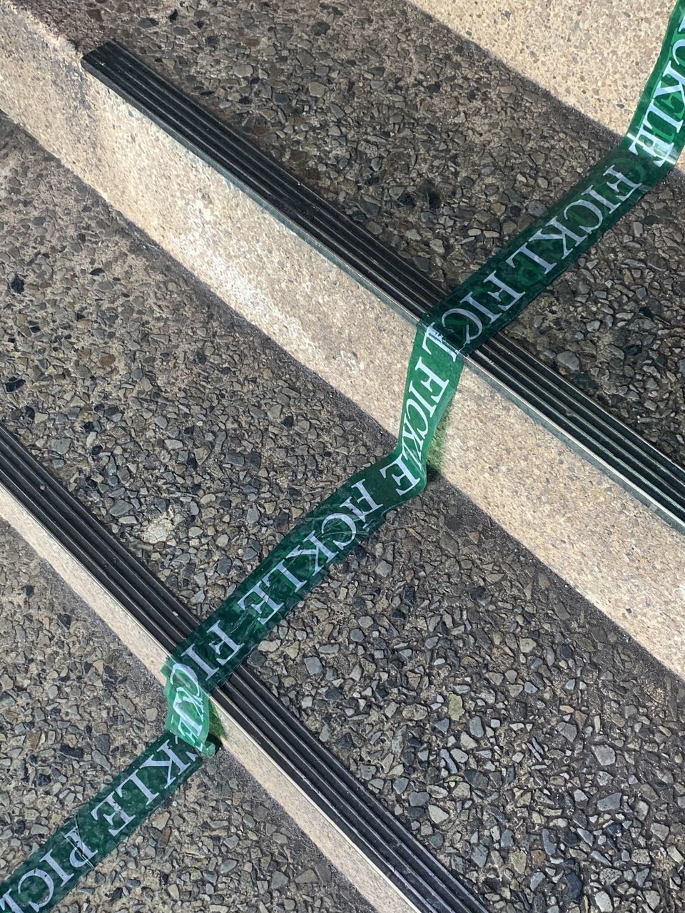 HIGH ANGLE VIEW OF ARROW SYMBOL ON RAILROAD TRACK