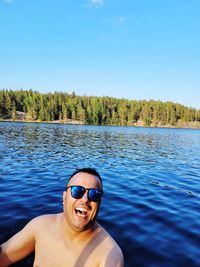 Portrait of man in sunglasses against blue sky