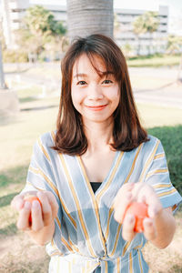 Portrait of smiling woman standing outdoors