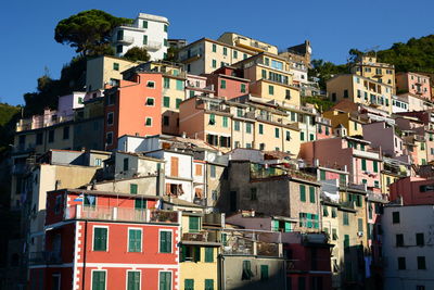 Buildings in city against clear sky