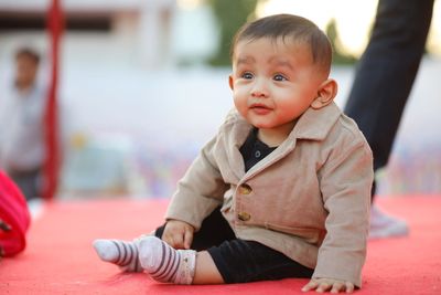 Portrait of cute baby sitting on floor