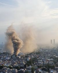 Smoke of fire explosion in a dense populated city of jakarta