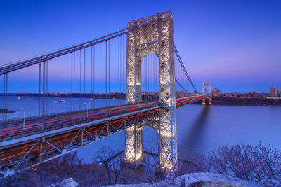 Wide angle view of illuminated bridge against sky