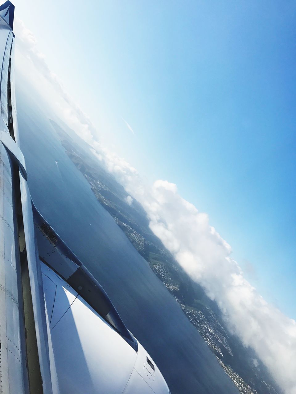 airplane, sky, transportation, day, no people, nature, blue, cloud - sky, beauty in nature, mode of transport, outdoors, journey, travel, tranquil scene, aerial view, scenics, vehicle part, sea, air vehicle, airplane wing, close-up