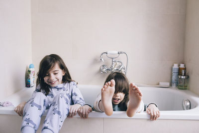 Portrait of smiling mother and daughter at home