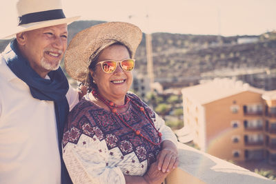 Smiling senior couple standing on building terrace