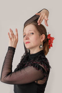 Portrait of woman standing against white background