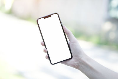 Close-up of hand holding mobile phone