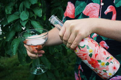 Midsection of woman drinking glass