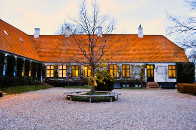 Houses by street against sky in city