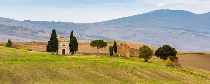 Scenic view of field and mountains against sky