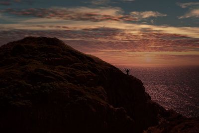Rock formation against sky during sunset