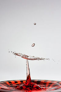 Close-up of water splashing against clear sky