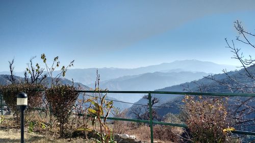 Scenic view of mountains against blue sky