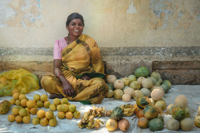 Full length of woman standing at market stall