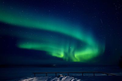 Scenic view of lake against sky at night