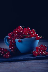 Close-up of strawberries on table against black background