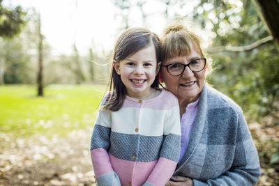 Granddaughter and grandmother in outdoor setting.