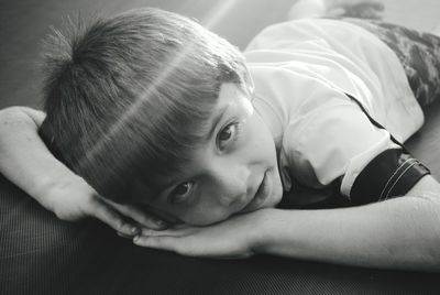 Portrait of boy lying on floor
