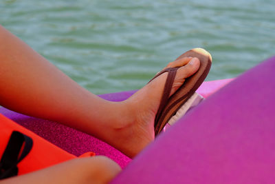 Low section of man in pedal boat on lake