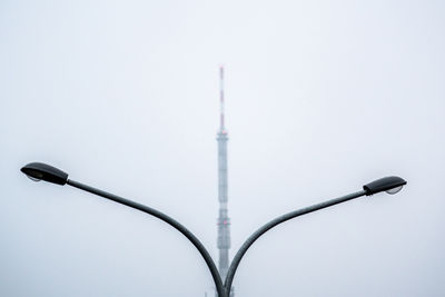 Low angle view of communications tower against sky