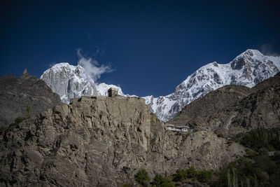 Scenic view of rocky mountains against blue sky