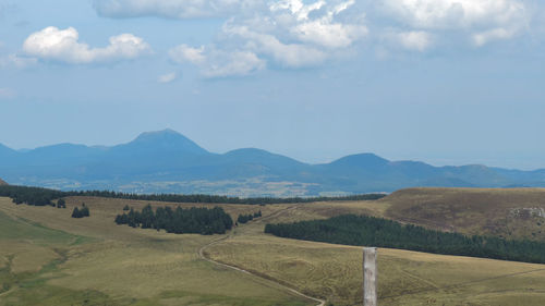 Scenic view of landscape and mountains against sky