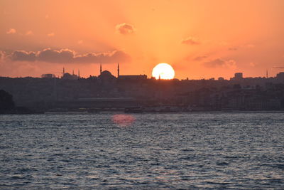 Scenic view of sea against orange sky