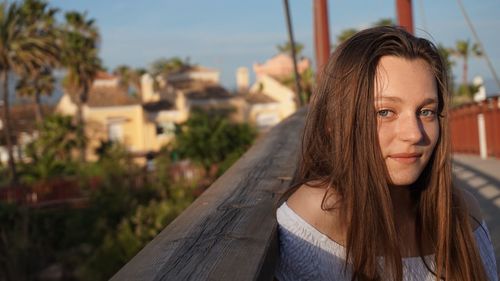 Portrait of beautiful woman against sky