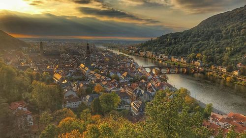 High angle view of townscape by river against sky