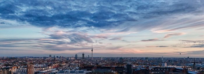 Cityscape against sky during sunset