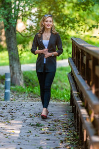 Full length portrait of woman on footpath