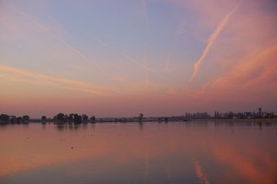 Scenic view of lake against sky during sunset