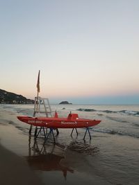 Lifeguard hut on beach against clear sky