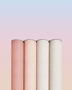 Low angle view of pink pencils against white background