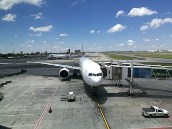 Airplane on runway against sky