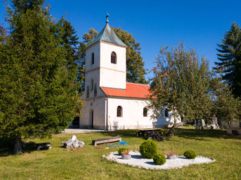 View of cemetery and building against sky