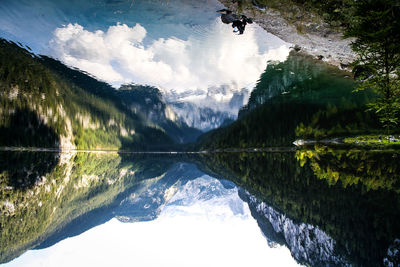 Upside down view of calm lake with mountains reflection