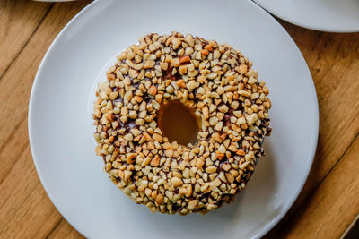 High angle view of peanut donut in plate on table